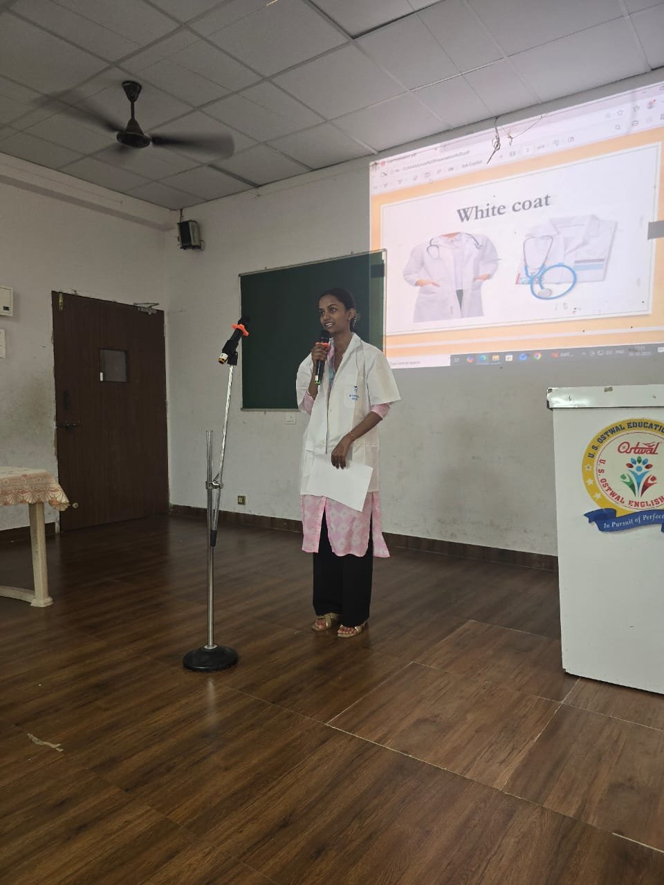 Student speaking at a microphone during a campus presentation